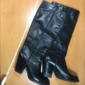 Shiny tall black leather boots